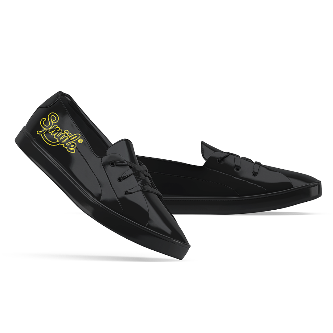 a pair of black shoes with yellow lettering Smyle™ on them