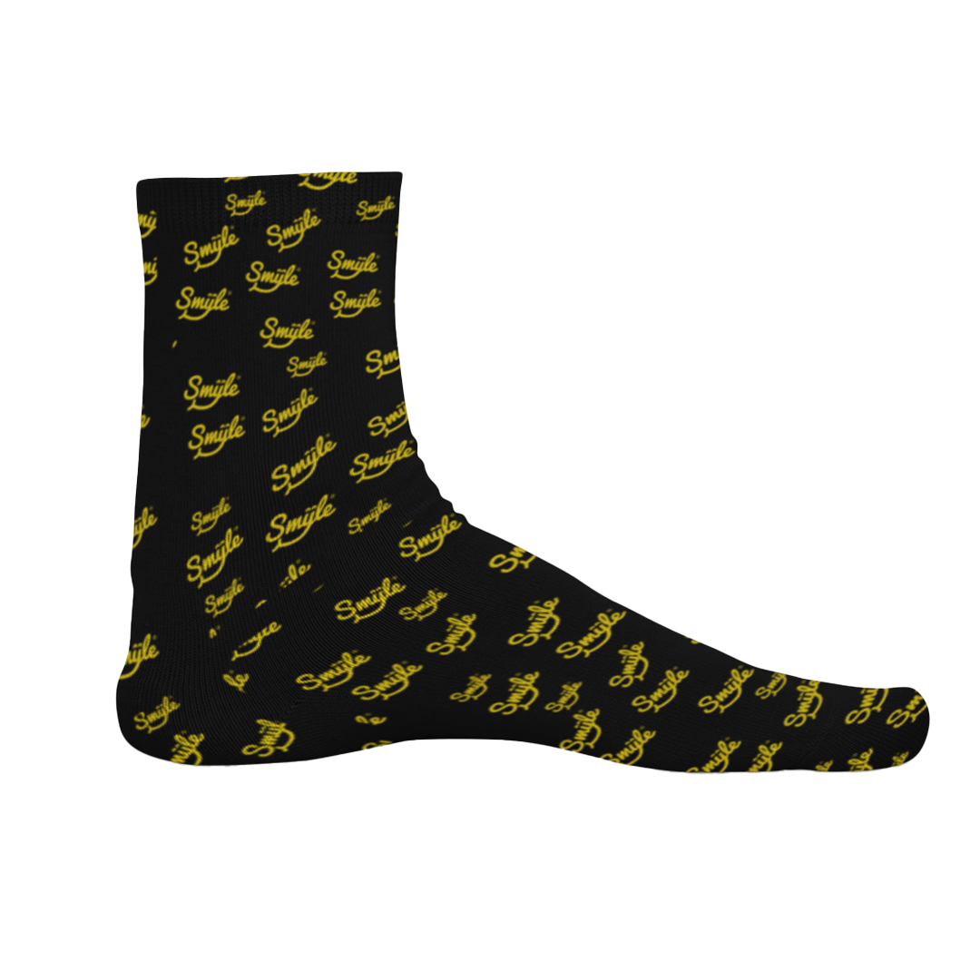 a pair of black socks with yellow Smyle™ on them